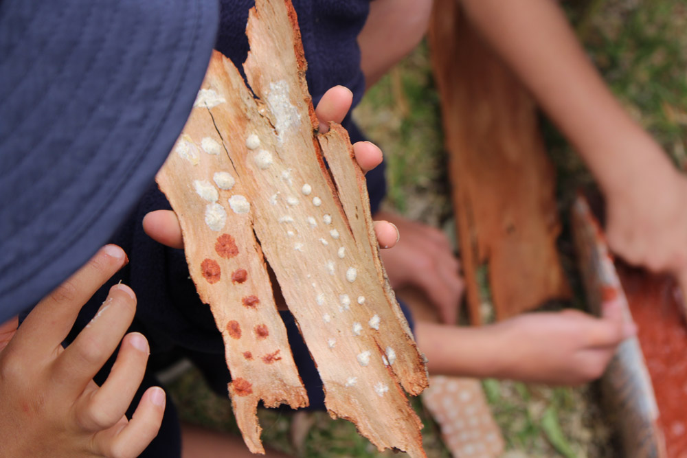 Students painting bark with ochre during Wathaurong/Waddawurrung cultural excursion