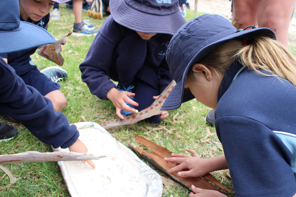 Students painting bark with ochre during Wathaurong/Waddawurrung cultural excursion